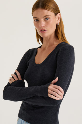 Model wearing a charcoal long-sleeve scoop top on a white background