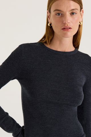 Model wearing a charcoal long sleeve top on a white background