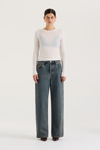 Female model wearing graphite wash wide leg and low rise Henne Gisella Jeans on a white background