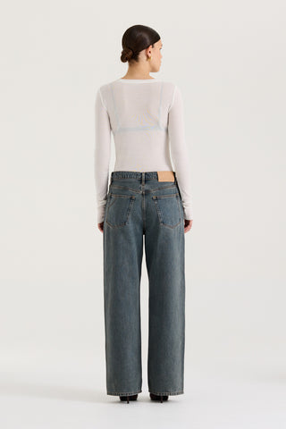 Back view of  model wearing graphite wash wide leg and low rise Henne Gisella Jeans on a white background
