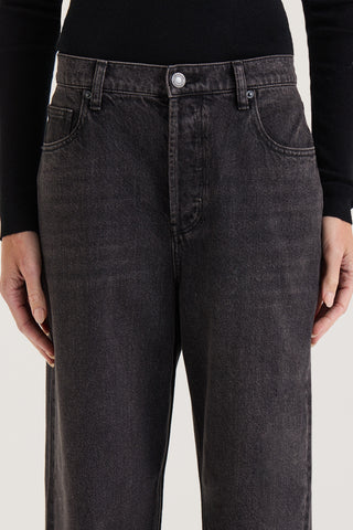 Close up view of models waistband wearing black wash wide leg, low rise Jeans on a white background 