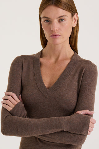 Model wearing a chocolate long sleeve top on a white background