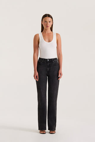 Model wearing Black Slim fitted jean and a fitted white tank top on a white background