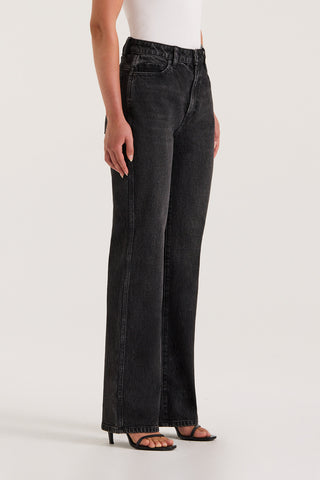Close up of a model wearing black slim jeans on a white background