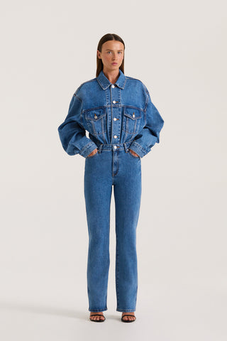 Petite Model wearing a Indigo denim jacket and Indigo slim fitted jeans on a white background