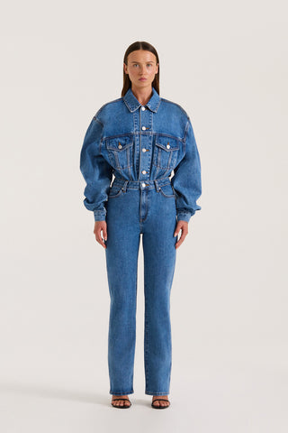 Petite model wearing a Indigo denim jacket and slim fitted jeans on a white background