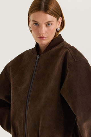 Model wearing a chocolate suede effect jacket against a white background
