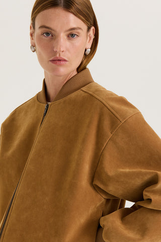 Model wearing a tanned suede effect jacket against a white background